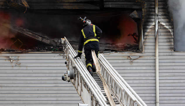 Firefighter Fighting Construction Fire Due To Gas Leaks, Explosions, And Fires In Reno