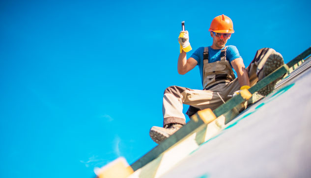 Man Working Precariously On A Roof In Reno