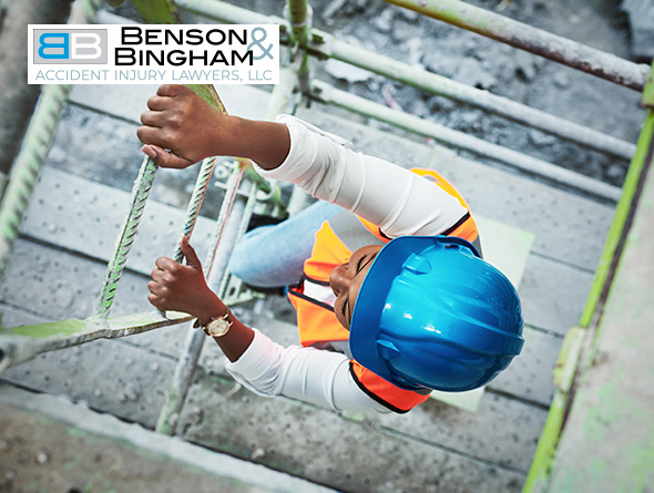 Construction worker in safety gear climbing scaffolding, potential subject for a Worker's Compensation Claim