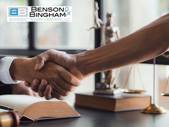 Lawyer and client handshake at Benson Bingham, concluding a Nevada Injury Claim discussion.