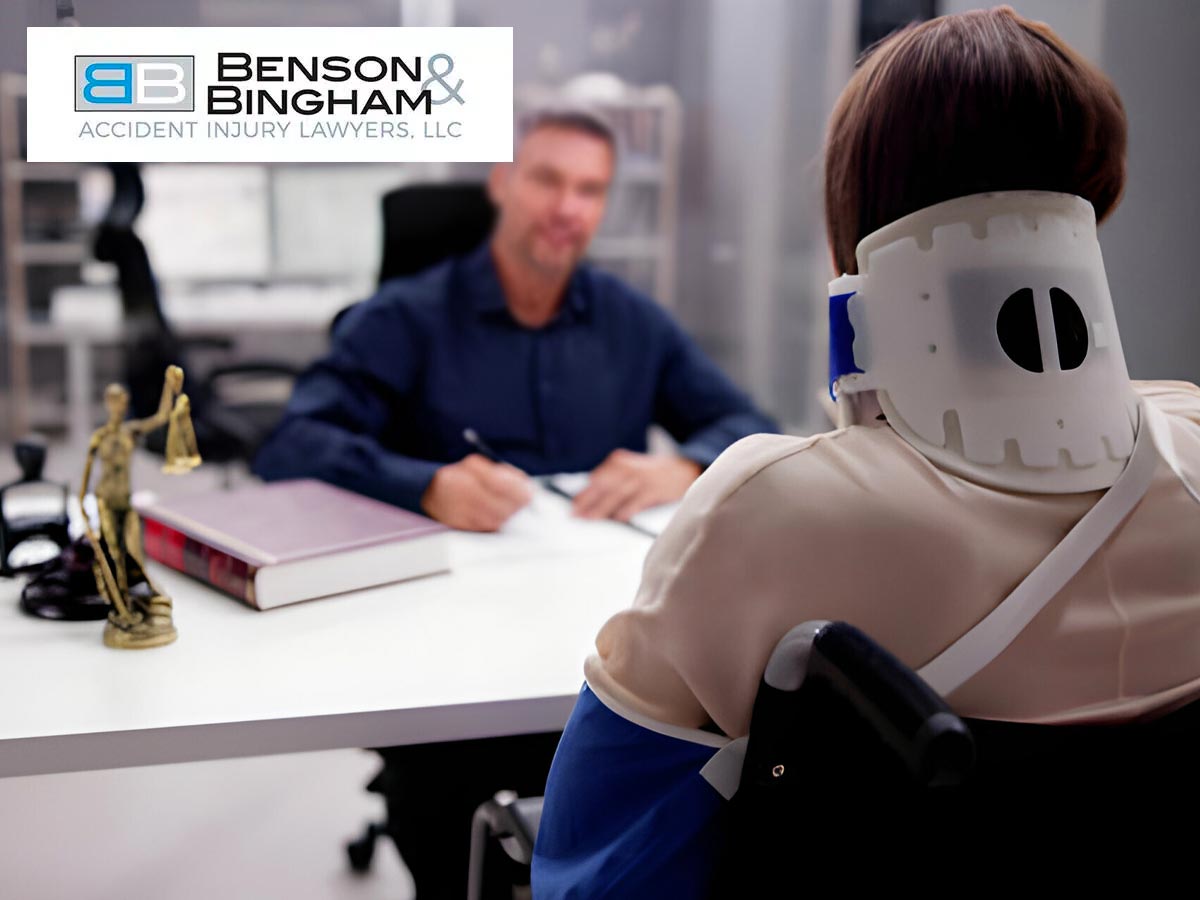 Person in neck brace and lawyer from Benson Bingham Accident Injury Lawyers, LLC discussing a case.