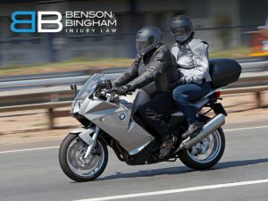 Passenger in a motorcycle accident riding with helmeted driver